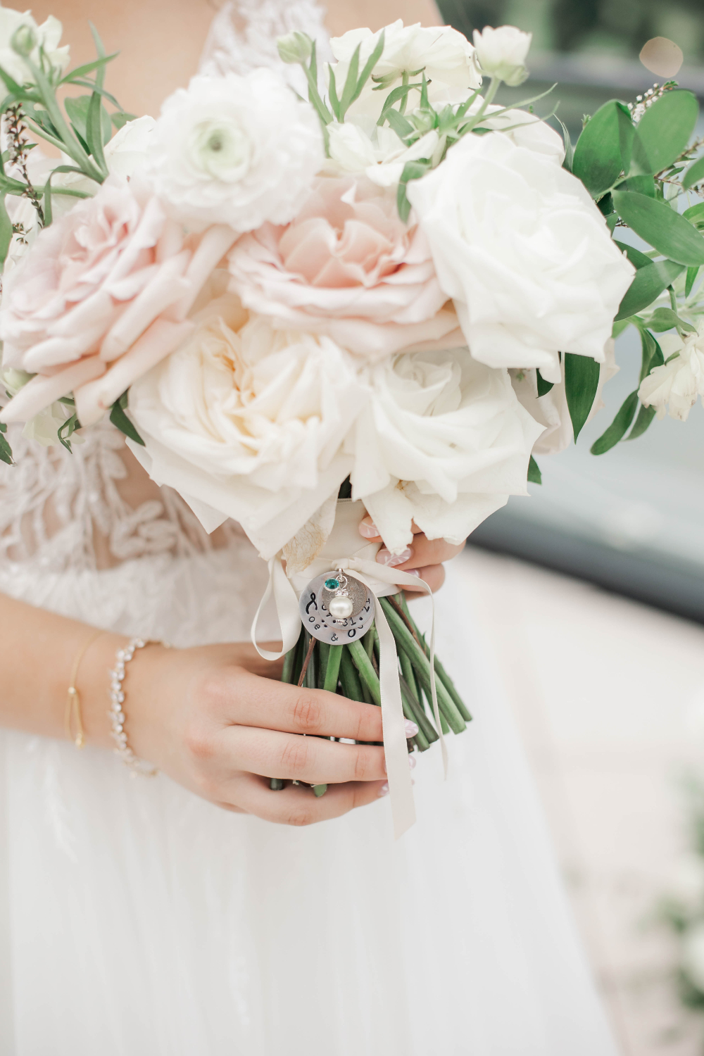 closeup of bridal bouquet with custom charm