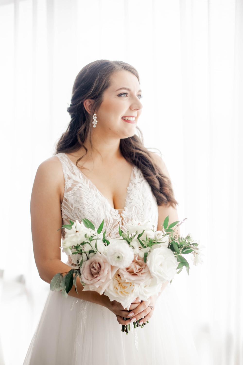 bride poses with classic wedding bouquet