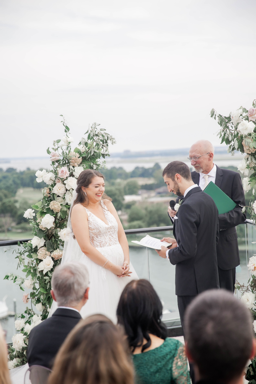 bride laughs as groom recites vows