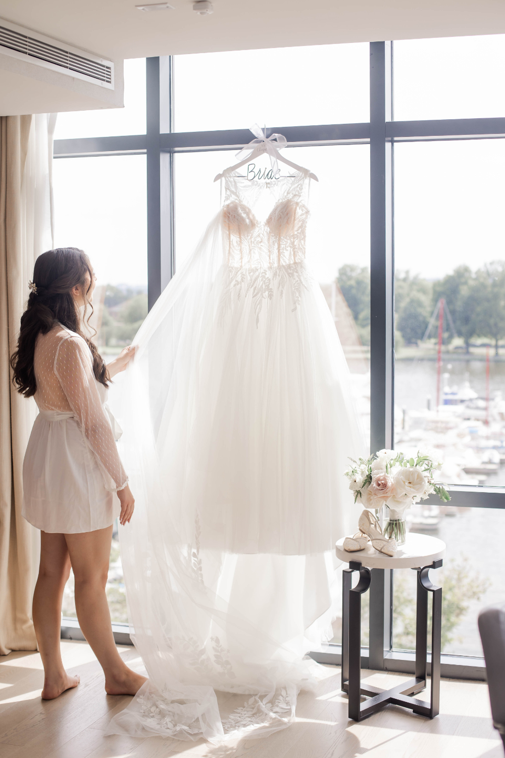bride looks at romantic lace wedding dress