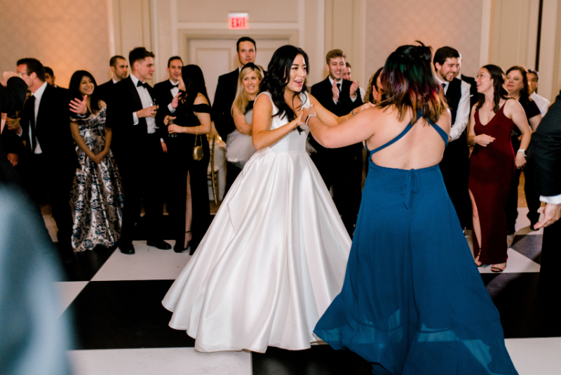 bride dances with guests on the dance floor