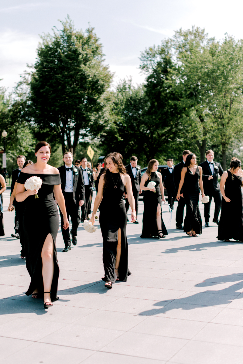 bridesmaids in black bridesmaid dresses during summer wedding