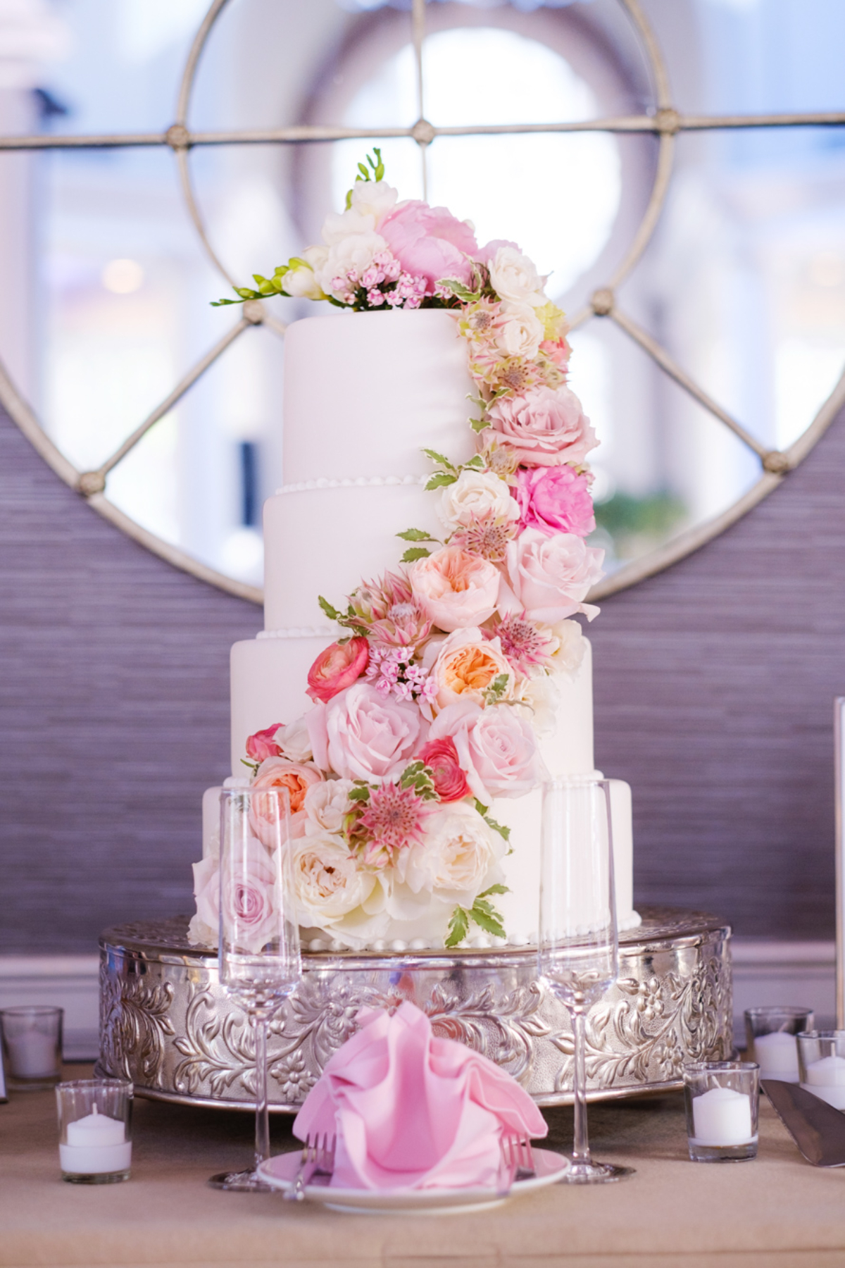 4 tier white wedding cake with pink florals