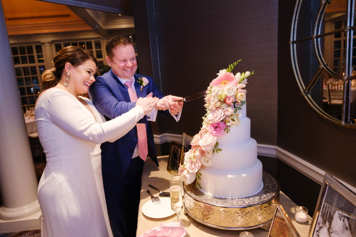 bride and groom cut the cake during wedding at the Fairmont Washington 
