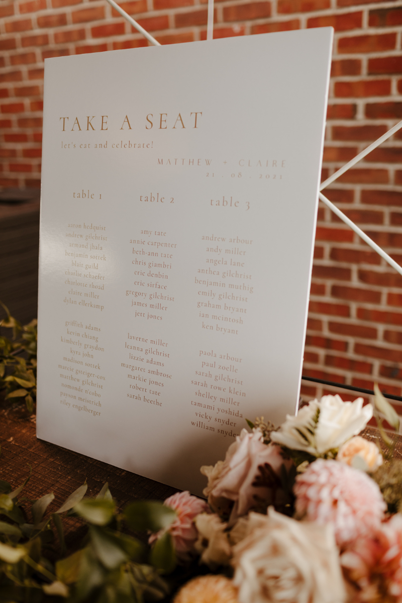 white seating chart with gold writing
