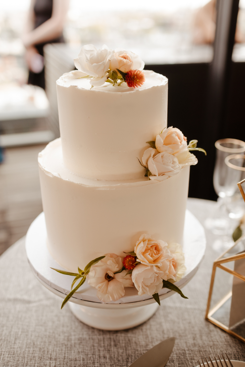 two tier white wedding cake with flowers