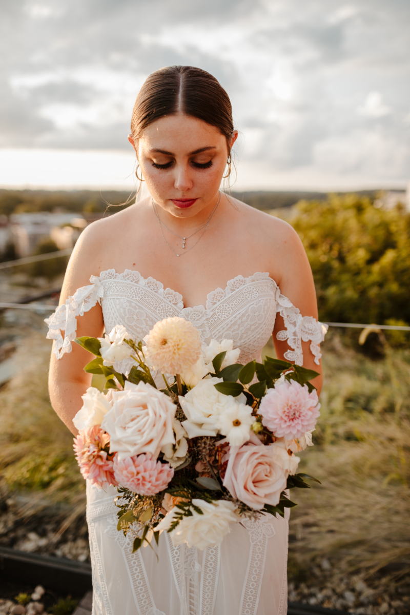 bride looks at gorgeous summer bouquet