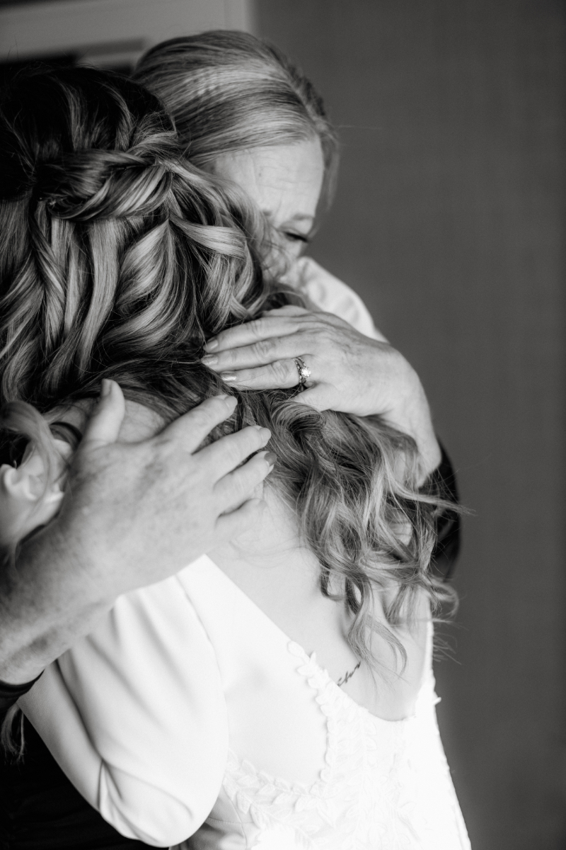 bride and her mom hug during getting ready photos