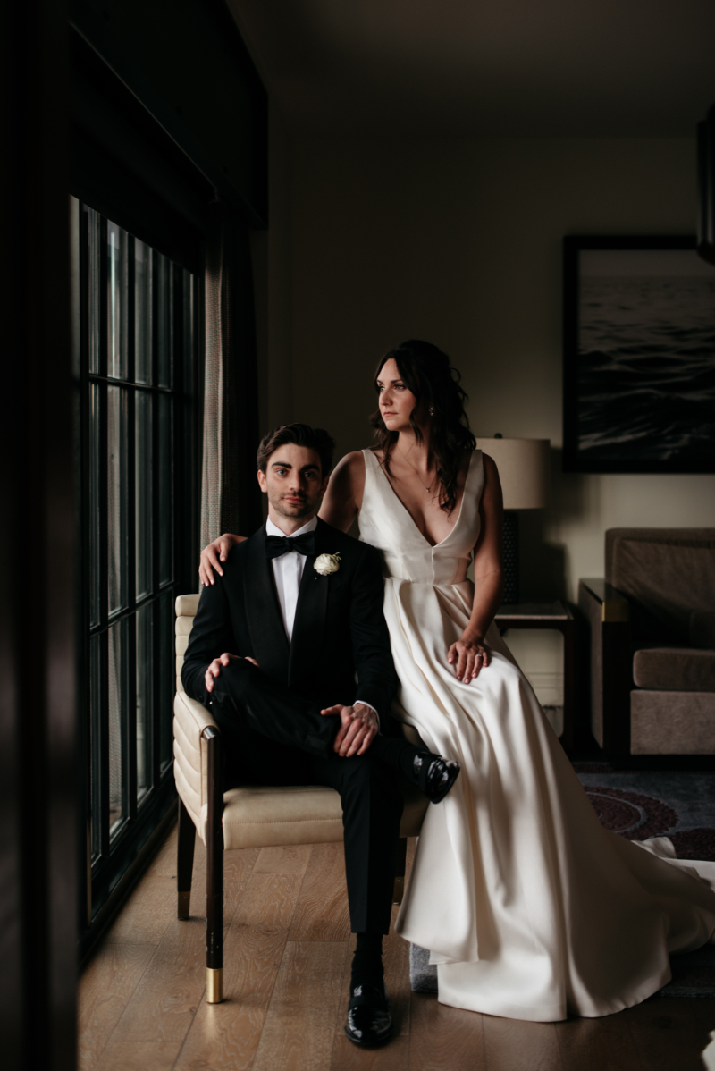bride and groom pose in hotel room