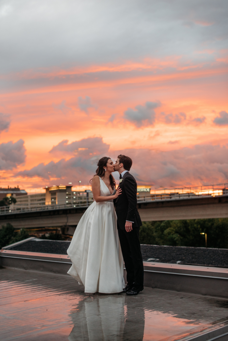 bride and groom take photos at sunset