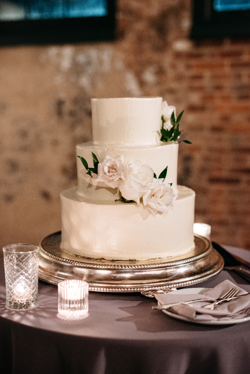 three tier white wedding cake with flowers
