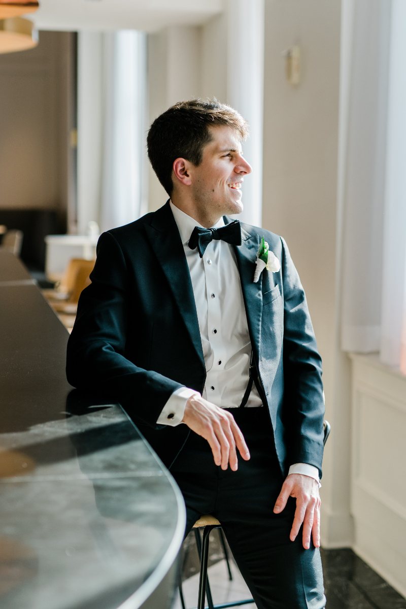 CLOSE UP OF GROOM IN HIS SUIT
