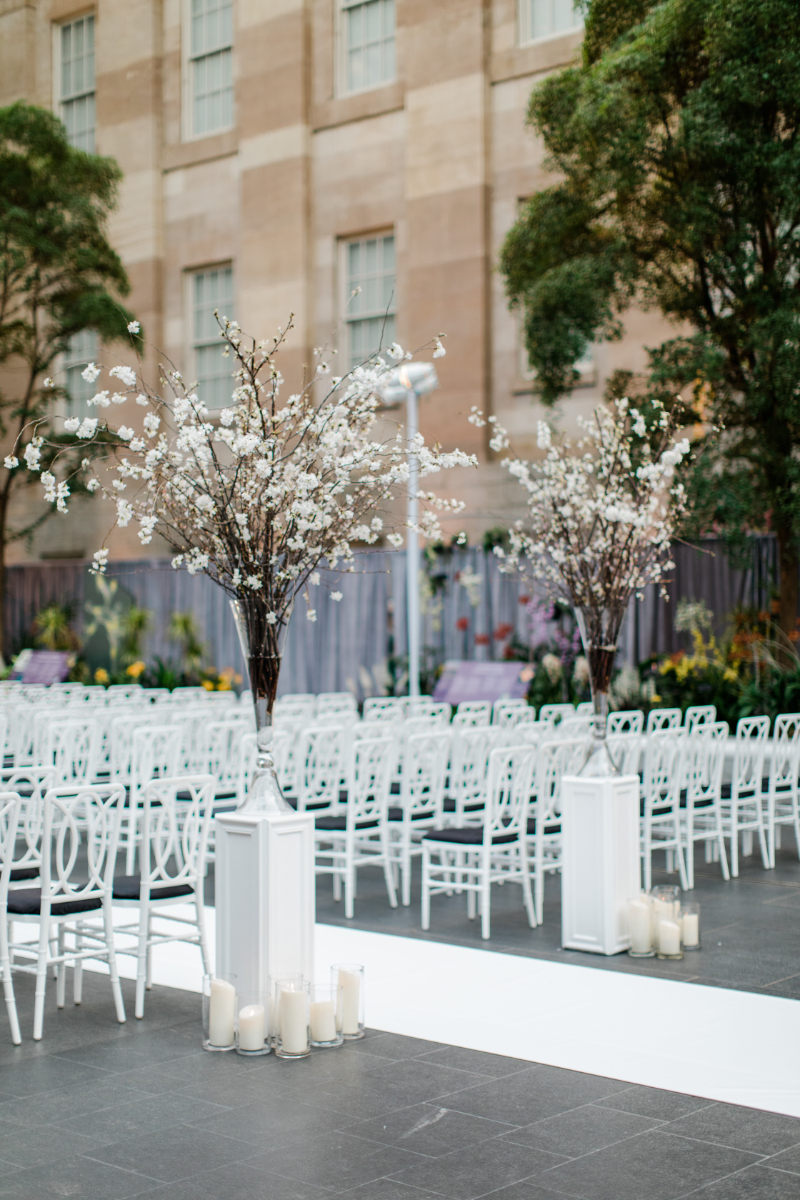 WHITE WEDDING CEREMONY AT NATIONAL PORTRAIT GALLERY CLOSE UP OF FLORAL ARRANGEMENTS