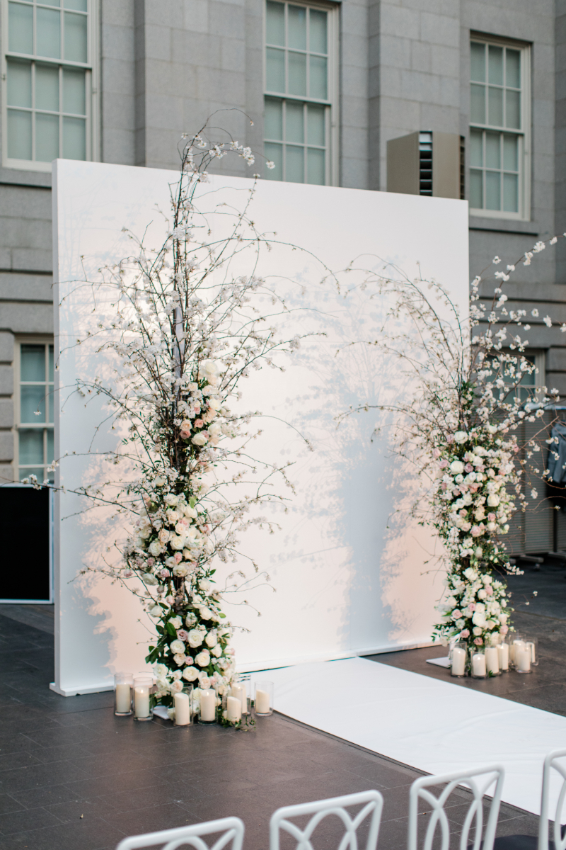 WHITE WEDDING CEREMONY AT NATIONAL PORTRAIT GALLERY CLOSE UP OF FLORAL/CANDLE ARRANGEMENTS