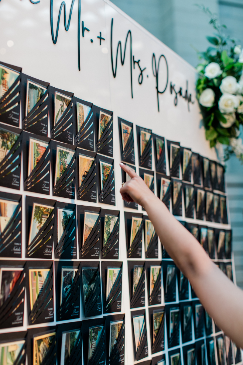 GUESTS ADMIRING PERSONALIZED ESCORT CARD WALL AT WEDDING RECEPTION AT NATIONAL PORTRAIT GALLERY