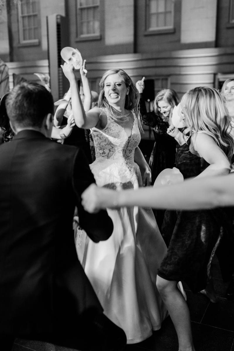 BRIDE DANCING WITH GUESTS AT WEDDING RECEPTION AT NATIONAL PORTRAIT GALLERY