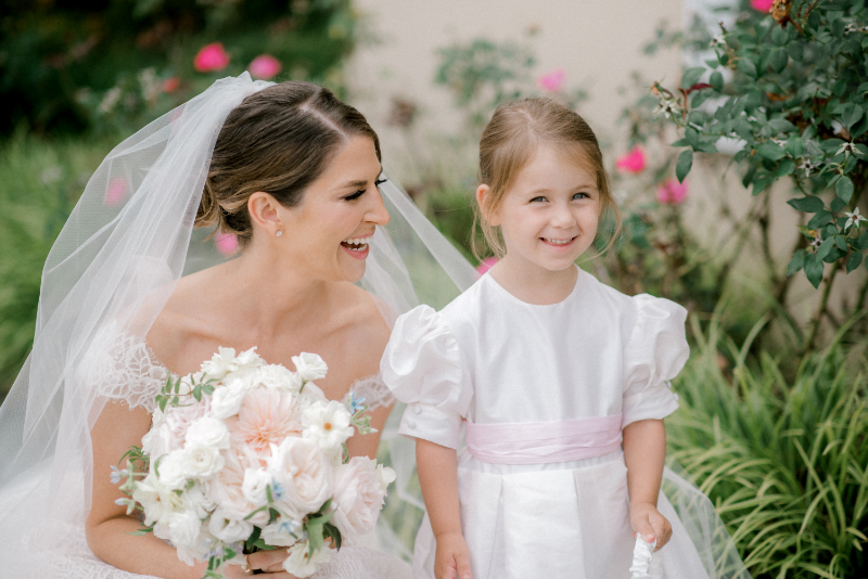 BRIDE SMILING WITH FLOWER GIRL
