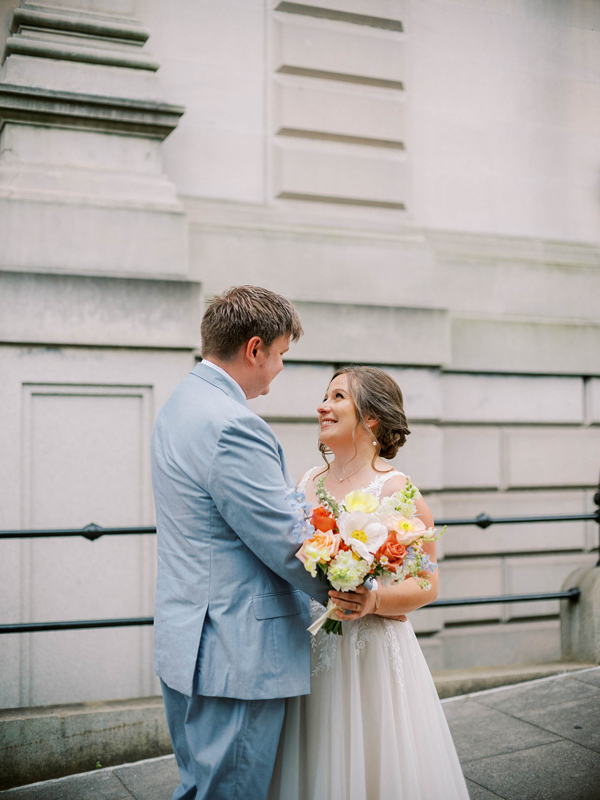 A BRIDE AND GROOM FIRST LOOK OUTSIDE OF THE PEABODY LIBRARY