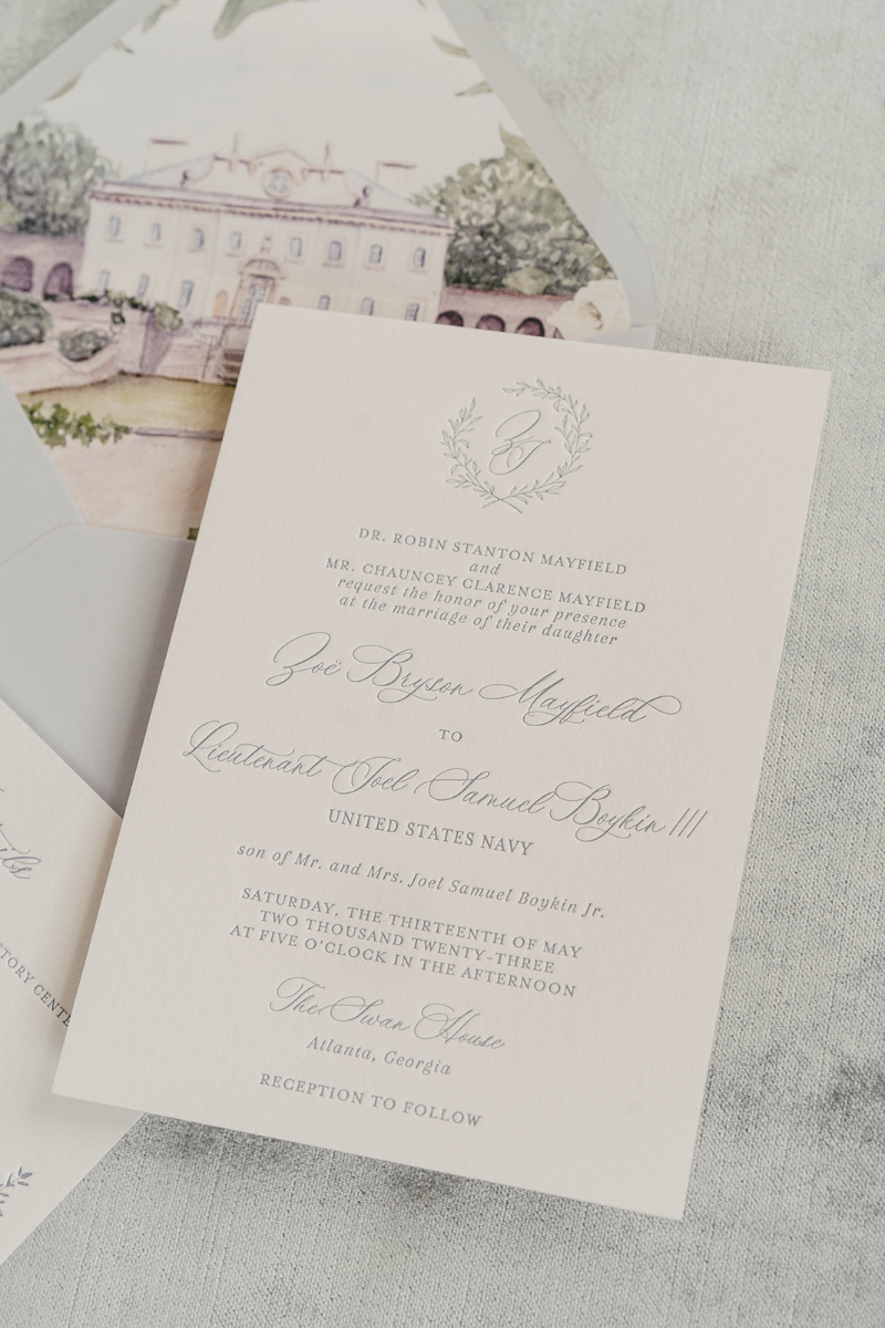 dusty blue custom wedding invitation suite with the atlanta swan house illustration on envelope liner 
