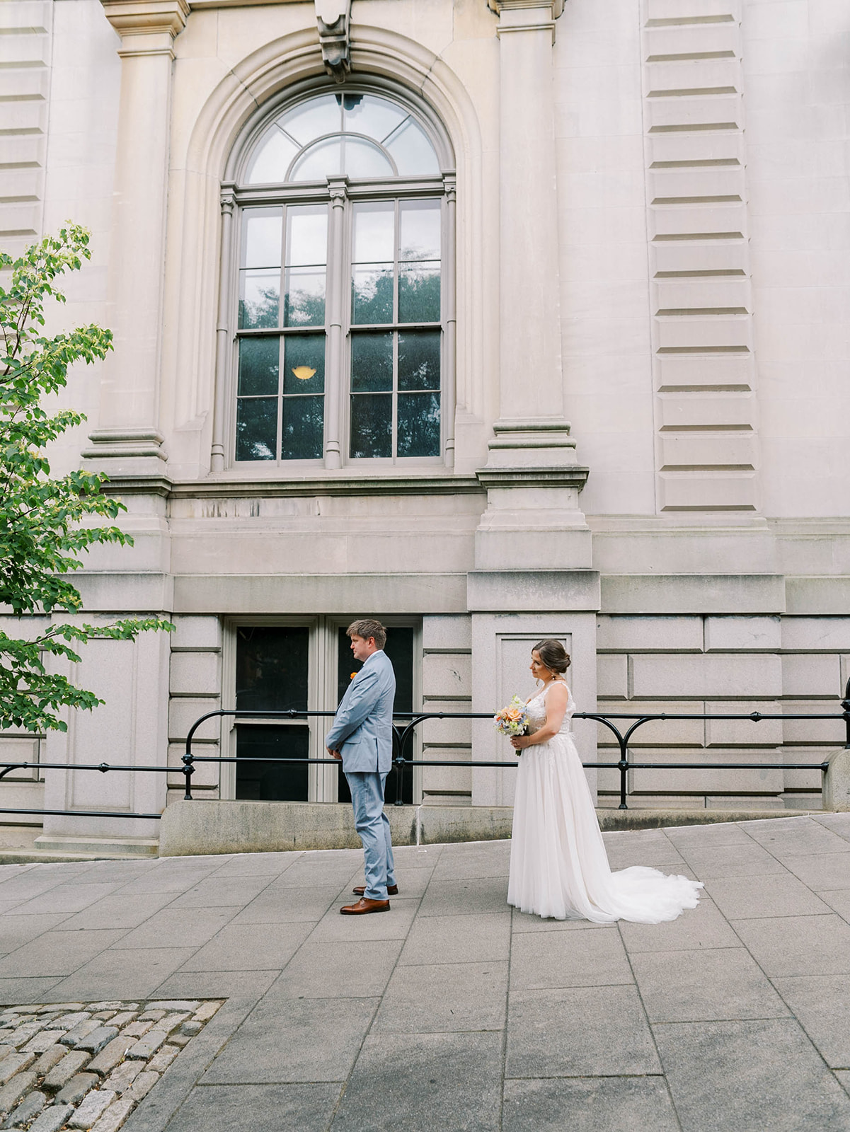 A BRIDE AND GROOM FIRST LOOK OUTSIDE OF THE PEABODY LIBRARY