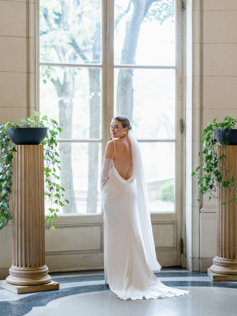 BRIDAL PORTRAIT SHOWCASING HER LOW BACK DRESS AND GLOVES