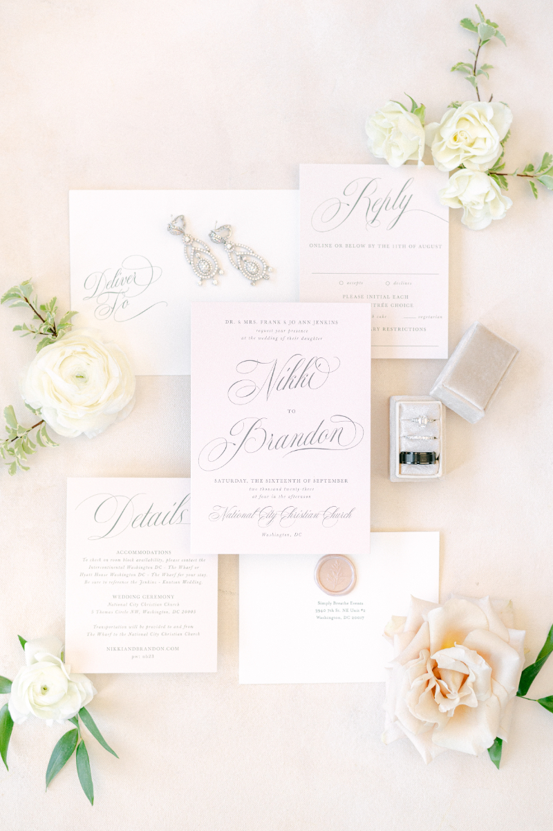 FLAT LAY OF WHITE AND BLACK WEDDING INVITATION SUITE 